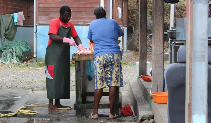 Woman cleaning fish