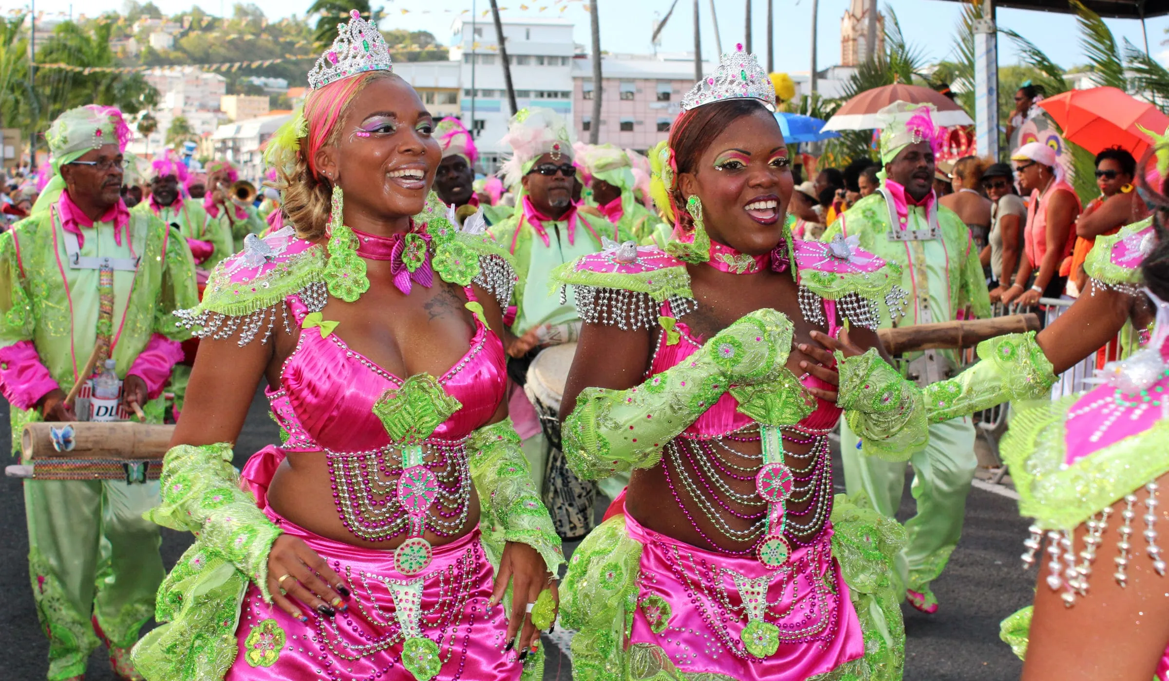 Women from a carnival group smiling during a parade