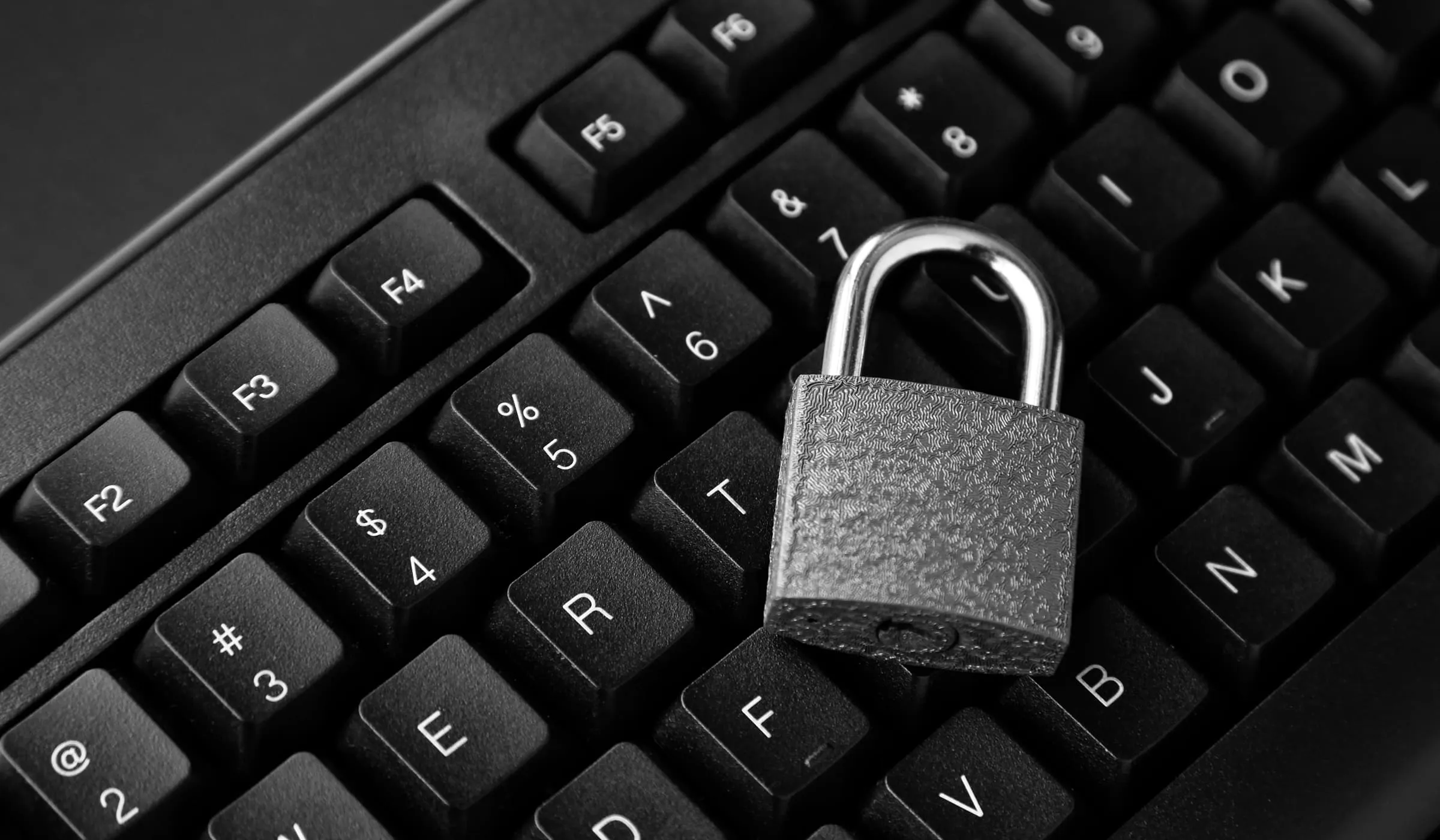 Computer keyboard with a padlock placed on the keys